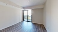 Located at 500 N Andrews Ave in Fort Lauderdale, this well-appointed one-bedroom, one-bathroom residence offers a thoughtfully designed open floor plan with modern finishes throughout. Wide-plank wood-style flooring flows seamlessly through the living, dining, and kitchen areas, creating a cohesive and contemporary aesthetic.

The kitchen is a standout feature, equipped with stainless steel appliances including a full-size refrigerator, range, and microwave. Sleek white cabinetry extends to the ceiling, complemented by a marble-style tile backsplash and quartz countertops. A central island with pendant lighting provides additional prep space and casual seating, while track lighting above adds functional illumination.

The living area is bright and open, anchored by floor-to-ceiling sliding glass doors that lead to a private balcony with outdoor views, allowing abundant natural light to fill the space.

The bedroom offers a comfortable footprint with two dedicated closets featuring built-in rods and shelving, providing generous storage. The bathroom is finished with a floating wood-toned vanity, quartz countertop, undermount sink, and a striking backlit LED mirror that lends a clean, spa-like ambiance.

Neutral wall tones and clean architectural lines give the entire residence a modern, move-in-ready appeal.