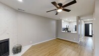 This thoughtfully renovated two-story home offers 2 bedrooms and 1 bathroom across two well-proportioned floors, combining modern updates with a clean, contemporary aesthetic throughout. Light wood-tone flooring flows seamlessly through every room, creating a warm and cohesive feel.

The main level features an open living room highlighted by a striking marble-surround fireplace, a ceiling fan, and French doors that invite natural light. The kitchen has been fully updated with white shaker cabinetry, quartz countertops, a bold black hexagon tile backsplash, stainless steel appliances, and a pass-through window to the living area. A laundry area and hallway complete the first floor.

Upstairs, both bedrooms are generously sized and feature vaulted ceilings and ceiling fans. The primary bedroom boasts dual mirrored sliding closets, providing ample storage. The second bedroom offers two windows with natural light. The bathroom is finished with a white vanity, modern matte black hardware, and a clean, minimalist design.

A staircase with white railings and wood-toned treads connects both floors. Neutral gray walls, recessed lighting, and consistent flooring throughout tie the entire home together in a polished, move-in ready package.