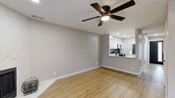 This thoughtfully renovated two-story home offers 2 bedrooms and 1 bathroom across two well-proportioned floors, combining modern updates with a clean, contemporary aesthetic throughout. Light wood-tone flooring flows seamlessly through every room, creating a warm and cohesive feel.

The main level features an open living room highlighted by a striking marble-surround fireplace, a ceiling fan, and French doors that invite natural light. The kitchen has been fully updated with white shaker cabinetry, quartz countertops, a bold black hexagon tile backsplash, stainless steel appliances, and a pass-through window to the living area. A laundry area and hallway complete the first floor.

Upstairs, both bedrooms are generously sized and feature vaulted ceilings and ceiling fans. The primary bedroom boasts dual mirrored sliding closets, providing ample storage. The second bedroom offers two windows with natural light. The bathroom is finished with a white vanity, modern matte black hardware, and a clean, minimalist design.

A staircase with white railings and wood-toned treads connects both floors. Neutral gray walls, recessed lighting, and consistent flooring throughout tie the entire home together in a polished, move-in ready package.