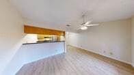 Located at 8615 Rockwood Ln in Austin, TX, this single-story, one-bedroom, one-bathroom home offers a well-organized layout that makes smart use of its cozy footprint. Light wood-style flooring flows consistently throughout, lending warmth and visual continuity to every room.

The combined kitchen and living area serves as the heart of the home. The living space is bright and open, with two large windows fitted with blinds that invite generous natural light, complemented by a ceiling fan overhead. The kitchen is positioned behind a raised bar-height peninsula with a dark countertop, creating a natural separation between cooking and living areas. Warm honey-toned wood cabinetry lines the kitchen walls, with overhead cabinets extending to the ceiling for ample storage. A stainless refrigerator and range complete the space.

The bedroom is comfortably sized, featuring the same light wood flooring, a ceiling fan with light kit, and a wide double-door closet offering generous storage. Multiple windows frame views of the surrounding brick exterior and greenery outside.

The full bathroom includes a soaking tub and shower combination with clean white tile surround, brushed nickel fixtures, and a wood-toned vanity cabinet. A hallway connects the rooms, completing this practical and pleasant single-floor layout in a well-established Austin neighborhood.