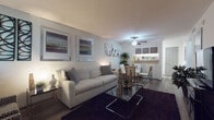 This single-story, one-bedroom, one-bathroom residence offers a thoughtfully arranged floor plan that maximizes its comfortable footprint. The living area serves as the heart of the unit, featuring wood-style flooring, a ceiling fan, and large windows fitted with blinds that allow natural light to fill the space. The open layout connects the living area directly to a dedicated dining space, creating a seamless flow ideal for everyday living and entertaining.

The kitchen runs adjacent to the dining area and is equipped with black appliances, including a range and refrigerator, white cabinetry, light countertops, and wood-style flooring, providing a clean, functional workspace.

The bedroom offers a quieter retreat, finished with plush carpeting, a ceiling fan, and a window with blinds. A closet door is visible, providing practical storage within the room.

The bathroom features wood-style flooring and a full tub-shower combination, keeping the space clean and straightforward in design.

Throughout the unit, neutral wall tones and consistent flooring choices create a cohesive, understated aesthetic, making the space feel organized and move-in ready.