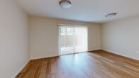 Located at 39900 Blacow Rd in Fremont, California, this well-appointed 2-bedroom, 1-bathroom single-floor residence offers a clean, modern aesthetic throughout. Warm wood-look flooring runs continuously across all living areas, creating a cohesive and inviting atmosphere.

The combined kitchen and living room serves as the heart of the home. The kitchen features sleek white cabinetry, marble-style countertops with a peninsula, a stainless steel refrigerator, and a built-in cooktop — a functional and stylish space for everyday living. The adjacent living area is bright and open, highlighted by a sliding glass door with vertical blinds that invites natural light and provides direct access to an outdoor patio area.

Both bedrooms are comfortably sized with neutral walls, wood-look flooring, and natural light from horizontal-blind windows that frame views of surrounding greenery. Each room includes a sliding-door closet, with the primary bedroom offering generous proportions. The second bedroom also benefits from a window with an outdoor view.

The bathroom is tastefully updated, showcasing marble-style tile surround in the tub/shower combination, a white vanity with modern hardware, and wood-look flooring that ties the space together cohesively. Clean lines and neutral tones throughout lend the residence a fresh, move-in-ready appeal.