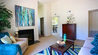 Located at 713 Willow Lake Cir in Virginia Beach, Virginia, this single-floor home offers a well-designed layout with a warm, inviting ambiance throughout. The living room is a standout space, boasting dramatic vaulted ceilings that amplify the sense of openness, a classic fireplace as a focal point, and French doors that flood the room with natural light and provide access to an outdoor area. The open flow connects seamlessly to the dining area, which features a stylish chandelier and a large window overlooking serene waterfront views — an ideal setting for everyday meals or entertaining. The kitchen is well-appointed with rich, dark cabinetry, stone-toned countertops, and wood-style flooring, offering ample storage and functionality. Multiple bedrooms provide comfortable retreats; the primary bedroom includes an en-suite bathroom and private access to a secondary room, while additional bedrooms feature generous closet space and plush carpeting. The bathrooms are finished with dark wood vanities and wood-style flooring, including a full tub and shower. A dedicated in-unit laundry area adds everyday convenience. Neutral tones and soft carpet throughout lend the home a cohesive, comfortable feel.