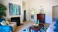 Located at 713 Willow Lake Cir in Virginia Beach, Virginia, this single-floor home offers a well-designed layout with a warm, inviting ambiance throughout. The living room is a standout space, boasting dramatic vaulted ceilings that amplify the sense of openness, a classic fireplace as a focal point, and French doors that flood the room with natural light and provide access to an outdoor area. The open flow connects seamlessly to the dining area, which features a stylish chandelier and a large window overlooking serene waterfront views — an ideal setting for everyday meals or entertaining. The kitchen is well-appointed with rich, dark cabinetry, stone-toned countertops, and wood-style flooring, offering ample storage and functionality. Multiple bedrooms provide comfortable retreats; the primary bedroom includes an en-suite bathroom and private access to a secondary room, while additional bedrooms feature generous closet space and plush carpeting. The bathrooms are finished with dark wood vanities and wood-style flooring, including a full tub and shower. A dedicated in-unit laundry area adds everyday convenience. Neutral tones and soft carpet throughout lend the home a cohesive, comfortable feel.