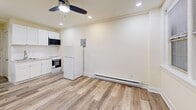 Located at 247-249 S Juniper St, Unit 203, in Philadelphia's vibrant Washington Square West neighborhood, this studio unit offers a thoughtfully designed single-floor layout that maximizes every square foot. The main living area is bright and open, finished with light-toned wood-style flooring that runs throughout, lending warmth and visual continuity to the space. Cream-colored walls and white trim create a clean, neutral backdrop, while recessed lighting and a ceiling fan with integrated light fixture ensure the room remains well-lit and comfortable year-round. A window unit air conditioner and baseboard heating provide climate control options across seasons. Natural light filters in through windows fitted with horizontal blinds, adding to the airy feel of the room. The compact kitchenette is efficiently appointed with white cabinetry, marble-look countertops, a stainless steel sink, an electric range with oven, an over-the-range microwave, and a full-size refrigerator — offering all essential cooking amenities within a streamlined footprint. A closet and bathroom are conveniently tucked adjacent to the living area, completing the functional layout. The unit's clean, updated finishes make it a practical and comfortable option in the heart of Philadelphia.