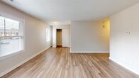 Located at 1102 W Poinsett St in Greer, South Carolina, this single-story home offers a clean, updated interior designed for comfortable living. Throughout the space, light wood-look luxury vinyl plank flooring provides a cohesive and easy-to-maintain foundation, complemented by neutral warm-beige walls and crisp white trim and baseboards. Textured ceilings add a classic touch to each room.

The open living area is bright and welcoming, featuring a front entry door with a modern hardware finish and windows fitted with horizontal blinds that allow natural light to filter in. The kitchen is outfitted with white shaker-style cabinetry accented by matte black hardware, gray laminate countertops, a stainless steel refrigerator, and a dishwasher, offering a functional and contemporary workspace.

The bedrooms are generously sized, each with windows providing natural light and outdoor views. Closet storage is well-represented, with at least one bedroom featuring a spacious reach-in closet with louvered bifold doors and a full-width hanging rod. Flush-mount light fixtures provide consistent illumination throughout.

The bathroom is finished with a full tub-and-shower combination unit, a sleek matte black fixture package including the faucet, showerhead, and towel bars, paired with gray countertops for a modern, coordinated aesthetic.