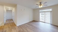 Located at 2557 S George St in York, PA, this single-floor unit offers a well-designed layout with clean, contemporary finishes throughout. The entry opens into a spacious living area featuring light wood-look luxury vinyl flooring, crisp white walls, and neutral tones that create a bright, welcoming atmosphere.

The kitchen is a functional highlight, outfitted with rich dark espresso cabinetry, light granite countertops, a stainless steel undermount sink, and a full suite of stainless steel appliances including a refrigerator, range, built-in microwave, and dishwasher. Recessed lighting illuminates the space, which also features wood-look flooring for easy maintenance.

The bedrooms are carpeted for comfort. The primary bedroom features multiple windows with blinds that allow for ample natural light, a ceiling fan with integrated lighting, and a walk-in closet. Additional bedrooms are similarly finished with carpet, neutral walls, and window views of the surrounding neighborhood.

The unit includes two bathrooms: one featuring a soaking tub with a grab bar and a dark-cabineted vanity with a granite countertop, and a second with a walk-in shower stall equipped with brushed nickel fixtures. Wood-look flooring runs through both bathrooms, contributing to a cohesive, modern aesthetic throughout the home.