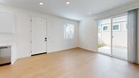 Located at 15912 Chase Rd in Fontana, CA, this single-floor 2-bedroom, 2-bathroom home offers a clean, modern design throughout. Warm wood-style flooring runs continuously across all living areas, complementing the crisp white walls and creating a cohesive, bright interior.

The open living area greets you at entry, featuring recessed lighting, a front door with secure hardware, a window with blinds, and a sliding glass door that opens to a private outdoor space with a small grassy area — ideal for enjoying Southern California's sunshine.

The kitchen is well-appointed with white shaker-style cabinetry, light quartz countertops, stainless steel appliances including a gas range, over-the-range microwave, dishwasher, and refrigerator, plus a stainless sink positioned beneath a window for natural light.

The primary bedroom offers a comfortable footprint with a sliding double-door closet and recessed lighting. The second bedroom also features a sliding closet, multiple windows with blinds that invite natural light, and clean white walls throughout.

Both bathrooms maintain the home's consistent design palette with wood-style flooring and white finishes — one includes a shower/tub combination with sliding glass doors, while the other features a dedicated walk-in shower stall with chrome fixtures.