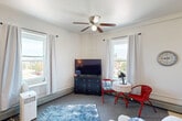 Located on the fourth floor at 801 Michigan Ave in La Porte, Indiana, this one-bedroom, one-bathroom unit offers a well-organized and efficiently designed layout across a single floor. The living room features plush carpeting, neutral white walls, and a ceiling fan with light fixture, creating a comfortable and functional gathering space. Natural light streams through multiple windows, offering pleasant outdoor views of the surrounding treetops and neighborhood. The bedroom is a well-proportioned retreat with soft carpeting, large windows dressed with curtains that frame greenery views, and a built-in closet providing ample storage. The kitchen is equipped with warm oak cabinetry, a tile backsplash, white appliances including an electric range and full-size refrigerator, and light tile flooring that adds brightness to the space. The bathroom features full white tile surround, a combined tub and shower with a handheld showerhead, and a window that brings in natural light. Throughout the unit, the clean white walls and carpeted floors create a calm, cohesive aesthetic. The fourth-floor position enhances the sense of privacy and provides elevated views that add to the overall appeal of this practical and inviting space.