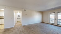 Located at 525 N Dupont Ave in Nashville, TN, this single-floor residence features 2 bedrooms and 2 bathrooms within a compact, efficiently organized layout. The living room is a bright, open space highlighted by French doors that invite natural light and provide outdoor views, complemented by neutral-toned carpet throughout. A hallway connects the main living areas to the bedrooms, creating a straightforward and functional flow.

The kitchen is well-appointed with white cabinetry, dark countertops, a double-basin sink, and white appliances including a coil-top range and refrigerator, all set atop easy-care tile flooring. Both bedrooms are carpeted and feature ceiling vents for climate control; the primary bedroom includes a ceiling fan with light fixture and a spacious closet with wire shelving behind bifold doors. The second bedroom also offers a closet and a window for natural light.

The two bathrooms provide practical amenities — one features a full tub-shower combination with built-in corner shelving and warm yellow tile accents, while the other includes a vanity with a vessel sink and dark countertop. Crisp white walls and clean finishes throughout lend the home a bright, neutral aesthetic ready for personalization.