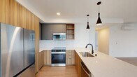 This spacious 1420 square foot apartment in Redmond, WA offers a blend of modern design and functional living. The single-floor layout encompasses three bedrooms, including a generous 190 square foot primary bedroom, and two full bathrooms. The heart of the home is an open-concept kitchen and living area, characterized by its sleek design and contemporary finishes. The kitchen boasts wooden cabinetry, stainless steel appliances, and a practical island with a built-in sink.

Large windows throughout the apartment flood the rooms with natural light, creating a bright and airy atmosphere. The bedrooms feature ample closet space and continue the modern aesthetic with neutral color palettes and wood-look flooring. Both bathrooms are outfitted with clean, white tile work and glass shower enclosures, maintaining the apartment's fresh, contemporary feel.

A dedicated laundry room with full-sized, stacked washer and dryer units adds convenience to daily living. The apartment's overall design emphasizes clean lines, neutral tones, and a minimalist approach, creating a canvas for personal style while ensuring a timeless appeal. With its thoughtful layout and modern amenities, this Redmond apartment offers a comfortable and stylish living space in a desirable location.