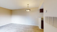 Located at 8061 Wood Scape Dr in Charlotte, NC, this single-floor residence offers a practical and comfortable layout designed for everyday living. The open living and dining area is finished with light wood-style flooring and warm neutral walls, creating a bright and welcoming atmosphere. A pendant light fixture anchors the dining space, which flows seamlessly from the living area. Natural light enters generously through a large front window, illuminating the main living space.

The galley-style kitchen is well-equipped with dark wood cabinetry, granite-style countertops, and black appliances including a refrigerator, electric range, and dishwasher. A pass-through counter connects the kitchen to the dining area, enhancing the open feel.

The bedroom features plush carpeting, a large window that invites natural light, and a mirrored sliding-door closet that adds both storage and a sense of spaciousness. The full bathroom includes a tiled tub and shower combination with classic white tile surround, a toilet, and clean, functional finishes throughout.

Overall, the space presents a clean, move-in-ready interior with a cohesive neutral palette, practical storage solutions, and a straightforward floor plan suited for comfortable residential living in Charlotte.