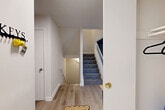 Located at 1623 Yale Pl in Rockville, Maryland, this multi-level home offers four bedrooms and four bathrooms spread across three thoughtfully organized floors. The entry level welcomes visitors with light hardwood-style flooring, clean white walls, and a carpeted staircase with classic wood railings, setting a bright and neutral tone throughout.

The main living level features two living areas, providing flexible space for lounging and entertaining. Large windows dressed with vertical blinds flood the rooms with natural light and offer pleasant outdoor views. The kitchen is equipped with stainless steel appliances, crisp white cabinetry with modern hardware, light countertops, and convenient open shelving — a functional and clean space for daily use.

The four bedrooms are well-sized, with the primary bedroom offering a generous footprint. Bedrooms are finished with carpeted floors and feature windows that bring in natural light. The bathrooms are cleanly finished with white tile surrounds, shower-tub combinations, and wood-toned flooring.

The lower level presents a versatile recreation room with carpet flooring, recessed ceiling details, and small windows that allow ambient light — an ideal space for leisure activities. A utility room rounds out the lower floor. Connecting all three levels, dual staircases with carpeted treads ensure smooth circulation throughout this well-structured Rockville home.