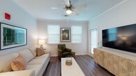 This single-floor residence offers a thoughtfully designed open-concept layout that seamlessly connects the kitchen, dining, and living areas. The kitchen is a standout feature, equipped with dark espresso shaker cabinets, stainless steel appliances including a refrigerator, range, and microwave, a mosaic tile backsplash, and a large granite-topped island with an undermount sink and bar seating — ideal for both meal preparation and casual dining. Pendant lighting above the island adds a refined touch, while recessed ceiling lights and crown molding elevate the overall aesthetic.

The living room is bright and welcoming, featuring dark hardwood-style flooring, a ceiling fan, crown molding, and multiple windows that allow generous natural light to fill the space. The bedrooms offer comfortable retreats; one features plush carpet, a ceiling fan, and a large window with outdoor views, while the other showcases a stylish accent wall. Both bathrooms are finished with granite countertops, dark wood vanity cabinetry, and wide mirrors. One bathroom includes a full tub-shower combo, while the other features a walk-in shower and access to a spacious walk-in closet. Consistent light-toned walls and quality finishes create a cohesive and modern ambiance throughout.