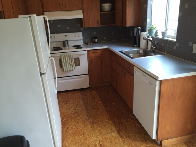 Kitchen Area, view from the dining area, with sliding door to the dining patio to the right - 6330 N Greeley Ave