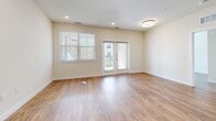 Located at 7121 Elroy Dr in Austin, TX, this single-story, 3-bedroom, 2-bathroom home offers a clean, modern design throughout. Warm wood-look flooring flows seamlessly across every room, complementing the neutral, cream-toned walls that create a bright and inviting atmosphere.

The kitchen is a standout feature, showcasing white shaker cabinetry, granite countertops, a central island with an integrated sink, and a full suite of stainless steel appliances including a refrigerator, range, microwave, and dishwasher. Recessed lighting adds a polished finish to this functional and stylish space.

The open living area is filled with natural light, thanks to large windows with slatted blinds and a glass door leading to an outdoor space, enhancing the sense of openness throughout. The primary bedroom offers a comfortable footprint with a ceiling fan and natural light from a large window. The additional bedrooms are equally well-lit and versatile.

Both bathrooms feature white subway tile tub-and-shower combinations with chrome fixtures and wood-look flooring, maintaining a consistent, clean aesthetic. A dedicated closet provides additional storage. The overall ambiance is fresh, modern, and move-in ready.