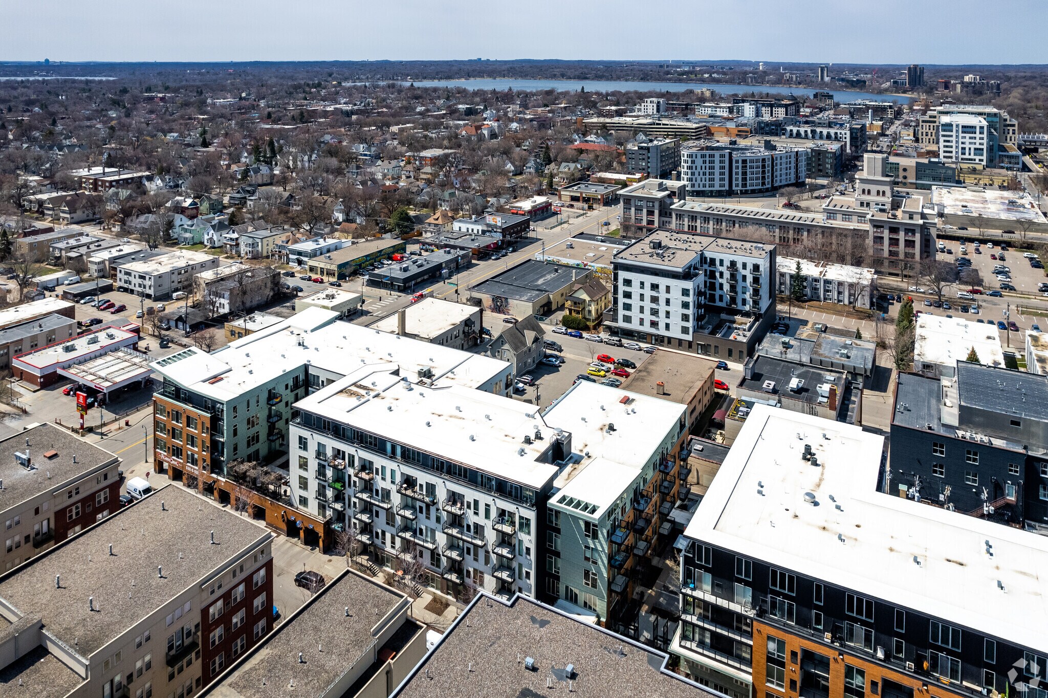 Aerial view of a modern apartment complex and surrounding urban neighborhood.