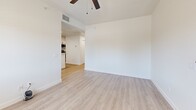 Located at 358 E Roeser Rd in Phoenix, AZ, this 2-bedroom, 1-bathroom residence offers a clean, modern aesthetic throughout its efficiently designed single-floor layout. Light wood-style luxury vinyl plank flooring runs continuously throughout the home, creating a cohesive and bright atmosphere.

The living room is an open, airy space equipped with a ceiling fan and connects seamlessly to the kitchen, which is a standout feature of the home. The kitchen showcases white shaker-style cabinetry with matte black hardware, stone-look countertops, recessed lighting, a peninsula with a undermount sink, and stainless steel appliances — delivering a contemporary and functional cooking space.

Both bedrooms are well-proportioned and include ceiling fans for comfort. Each room benefits from windows fitted with blinds that allow natural light to filter in while maintaining privacy. The primary bedroom includes a spacious closet enclosed by stylish sliding barn doors with black iron hardware, adding a modern farmhouse touch.

The bathroom is finished with white tile walls and features a full tub-shower combination with a glass sliding door and brushed nickel fixtures. Clean white walls and wood-tone flooring keep the space feeling fresh and cohesive. The front entry opens to a bright foyer with a windowed front door, offering a welcoming introduction to the home.
