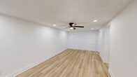Located at 2875 Palumbo Dr in Lexington, KY, this 2-bedroom, 1-bathroom single-story home offers a thoughtfully updated interior with clean, modern finishes throughout. Light-toned luxury vinyl plank flooring runs through the main living areas, complemented by crisp white walls and recessed lighting that create a bright, welcoming atmosphere.

The spacious living room features a ceiling fan with light, wainscoting panel detail along the lower walls, and recessed lighting, lending the space a polished, contemporary feel. An adjacent dining area flows naturally from the kitchen, which stands out as a highlight of the home. It is equipped with white shaker-style cabinetry with matte black hardware, granite countertops, a classic white subway tile backsplash, and stainless steel appliances including a range, microwave, and dishwasher.

Both bedrooms are carpeted and equipped with ceiling fans, offering a comfortable retreat. Each room receives natural light through windows with blinds. The bathroom includes a full soaking tub and shower combination with a rainfall-style showerhead and matte black fixtures.

A dedicated laundry room houses a full-size washer and dryer along with a water heater, adding everyday convenience. Two closets provide ample storage. The home's cohesive, modern aesthetic and functional layout make it an efficient and comfortable living space.