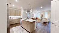 Located at 2850 Iris Ave in Boulder, CO, this well-appointed 2-bedroom, 2-bathroom residence offers a single-floor open-concept layout with a clean, contemporary aesthetic throughout. Rich wood-look flooring anchors the main living areas, while crisp white walls and recessed lighting create a bright, welcoming atmosphere.

The kitchen serves as the heart of the home, featuring a large center island with a sink and seating, light wood cabinetry, white quartz countertops, stainless steel appliances, under-cabinet lighting, and a dedicated pantry. Pendant lights above the island add a stylish accent. The kitchen flows seamlessly into the living room, which is filled with natural light from large windows.

The spacious primary bedroom offers plush carpeting, generous wall space, and direct access to a well-designed en-suite bathroom. The primary bath includes a wood-toned vanity with quartz countertops, a walk-in shower with glass enclosure, and a walk-in closet. The second bedroom also features large windows and soft carpeting, complemented by a second full bathroom with a matching vanity design.

Additional highlights include three closets, an in-unit laundry area, and a private balcony. The layout is thoughtfully organized to maximize functionality and comfort in every room.