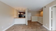 Located at 499 Northside Cir in Atlanta, GA, this two-floor residence offers a well-organized layout with distinct living spaces spread across both levels. The main living area features wood-look plank flooring and neutral warm-toned walls, with a bright triple-panel window that invites generous natural light. A pass-through kitchen opens directly to the living and dining areas, creating a connected, open feel. The kitchen is equipped with dark espresso cabinetry, granite countertops, black appliances including a refrigerator, electric range, and microwave, and a classic subway tile backsplash. Pendant lighting above the breakfast bar adds a functional yet stylish touch. The dining area features chair-rail molding and recessed lighting, contributing to a polished finish. Bedrooms are carpeted for comfort and feature neutral walls and window treatments that allow for natural light. Multiple bathrooms include full tub-shower combinations, wood-look tile flooring, dark vanity cabinetry, and granite countertops. The upper level, accessible via a staircase, includes additional carpeted living or bedroom space with closet access. Textured ceilings are consistent throughout the space, adding subtle architectural character to each room.