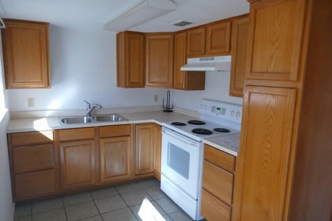 Modern kitchen, lots of cabinets, brand-new sink, brand-new refrigerator/freezer, stove, microwave - 410 Guadalupe St