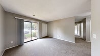 Located at 2400 Andrew Ave in La Porte, Indiana, this single-floor home offers a practical and comfortable layout across a generous footprint. The space includes two bedrooms, one full bathroom, a kitchen, an entrance, and a closet, all arranged for efficient everyday living.

The kitchen is a standout functional space, designed in a galley style with warm honey-toned wood cabinetry extending to the ceiling for ample storage. Granite-look countertops provide a durable work surface, while a stainless steel electric range and a white refrigerator complete the appliance lineup. Light wood-look flooring runs throughout the kitchen, adding a clean, modern contrast to the cabinetry.

Both bedrooms are finished with soft, neutral-toned carpet and painted in a calming greige palette. The primary bedroom offers a comfortable sense of space, with natural light filtering in through a sliding window. A dedicated closet adds convenient storage. The second bedroom also features carpeted flooring and a window view, maintaining the same clean, understated aesthetic throughout.

The bathroom is a refined highlight of the home, featuring a full tub-shower combination elegantly surrounded by dramatic marble-patterned wall panels in white and grey — lending the space a sophisticated, upscale feel.

Overall, the home presents a clean, move-in-ready interior with consistent neutral finishes throughout.
