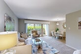 Located at 2100 Brooks Dr in District Heights, MD, this one-bedroom, one-bathroom residence offers a thoughtfully designed single-floor layout. The entrance opens into a carpeted living room bathed in natural light from large sliding glass doors that frame views of lush greenery outside. The open-concept layout flows seamlessly into a dedicated dining area, distinguished by a pendant light fixture overhead and its own sliding glass door access, creating a bright and airy atmosphere throughout. The kitchen features light wood cabinetry, dark granite-style countertops, black appliances including a gas range and dishwasher, and tile flooring — providing both functionality and style. The spacious bedroom offers generous proportions with soft carpet underfoot and includes two closets for ample storage. The neutral, warm-toned palette carried throughout the residence lends a cohesive and calming ambiance. Soft carpet in the main living areas and bedroom, combined with consistent natural light, makes this a comfortable and inviting space. The layout also includes a dedicated entrance area, completing a well-organized and practical floor plan suited for comfortable everyday living.