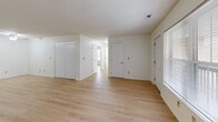 Located at 3602 N Kingston Dr in Peoria, Illinois, this single-floor, two-bedroom, two-bathroom home offers a practical and well-organized layout. Light hardwood flooring runs consistently throughout the entire space, lending a clean, cohesive aesthetic to every room.

The combined kitchen and living area forms the heart of the home. The kitchen is equipped with warm oak cabinetry providing ample storage, light-toned countertops, and a full suite of black appliances including a refrigerator, electric range, microwave, and dishwasher. A ceiling fan overhead adds comfort and functionality to the space.

Both bedrooms are bright and well-proportioned, each featuring large windows fitted with blinds that bring in generous natural light and offer views of the surrounding landscape. The primary bedroom is notably spacious and includes closet access, while the second bedroom provides a comfortable, versatile space. A wide hallway connects the bedrooms and living areas, contributing to an open and navigable floor plan.

The two bathrooms are clean and straightforward in design — one features a walk-in shower stall with chrome fixtures, and the other includes a full soaking tub with a tiled surround. Together, they offer practical accommodations for daily use. Overall, this home delivers a functional and well-lit living environment.