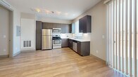 Located at 1552 Xavier St in Denver's vibrant West Colfax neighborhood, this one-bedroom, one-bathroom unit offers a thoughtfully designed, efficient floor plan across a single level. Light-toned hardwood-style flooring runs throughout, creating a cohesive and clean aesthetic.

The kitchen is a standout feature, equipped with stainless steel appliances including a gas range, microwave, refrigerator, and dishwasher. Dark espresso cabinetry is paired with crisp white countertops, and a window above the sink allows natural light to fill the space. Track lighting overhead provides functional illumination.

The living area is bright and open, featuring recessed lighting and a neutral color palette that maximizes the sense of space. The bedroom offers a window with blinds that invite natural light and include a sliding closet door for convenient storage. The unit also benefits from three closets in total, providing ample storage throughout.

The bathroom is accessed through a charming barn-style door and features large-format tile flooring, a single vanity with dark wood cabinetry and gold hardware, a wall mirror, and a shower-tub combination. A bright hallway with recessed lighting connects the rooms, and in-unit laundry adds everyday convenience to this well-appointed Denver residence.