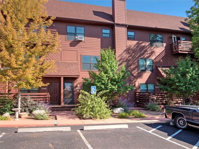 Front view with dedicated parking space to the left of a handicap space - 2270 Stepping Stones Way