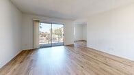 Located at 545 W Sixth St in the San Pedro neighborhood of Los Angeles, this one-bedroom, one-bathroom unit offers a bright and efficiently designed single-floor layout. Light wood flooring runs throughout the entire unit, creating a warm, cohesive feel against the crisp white walls and textured ceilings.

The open-concept living, dining, and kitchen area serves as the heart of the unit. Large sliding glass doors flood the living space with natural light and provide direct access to a private balcony with street-facing views. The galley-style kitchen is lined with white cabinetry on both sides, offering ample storage, along with a stainless steel gas range, a dishwasher, and a sink with countertop workspace.

The bedroom is a well-proportioned, quiet retreat featuring a window for natural light and a closet with sliding doors and a built-in hanging rod. The bathroom is fitted with a full tub and shower combination, a window for ventilation, a toilet, and a vanity with sink. A hallway connects the private areas of the unit to the main living space, completing the functional floor plan.