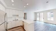 Located at 425 Garden St in the heart of Santa Barbara, this well-appointed 3-bedroom, 2-bathroom residence offers a clean, modern aesthetic throughout its single-floor layout. Light-toned wood-look flooring flows seamlessly from room to room, complementing the bright white walls and creating a cohesive, contemporary feel.

The open-concept kitchen and living area serves as the hub of the home. The kitchen is outfitted with crisp white cabinetry extending to the ceiling, a quartz peninsula with ample counter space, stainless steel appliances including a refrigerator, microwave, and range, and recessed lighting overhead — ideal for both everyday living and entertaining.

Each of the three bedrooms is filled with natural light courtesy of large windows that frame views of surrounding greenery. The spacious primary bedroom features sliding glass doors that open to an outdoor area, enhancing the connection to Santa Barbara's pleasant climate. The secondary bedrooms offer comfortable proportions and bright window outlooks.

The two bathrooms maintain the home's clean design language, featuring white surrounds, wood-look flooring, and simple pedestal and vanity sink options. One bathroom includes a walk-in shower, while the other offers a shower-tub combination. A hallway connects the bedrooms and bathrooms, providing a functional and well-organized flow throughout the residence.
