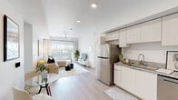 Located in Phoenix, AZ, this thoughtfully designed 2-bedroom, 2-bathroom residence offers a bright and modern living experience across a single floor. The open-concept layout seamlessly connects the kitchen, dining, and living areas, creating a cohesive and functional space ideal for everyday living and entertaining. Light wood-style flooring flows throughout, complementing the crisp white walls and recessed lighting that enhance the airy atmosphere.

The kitchen is outfitted with sleek white cabinetry, granite-style countertops, and a full suite of stainless steel appliances, including a refrigerator, range, microwave, and dishwasher. The living room features a ceiling fan, large sliding glass doors that flood the space with natural light, and direct access to a private outdoor area.

The primary bedroom is generously sized with elevated ceilings, a ceiling fan, a closet, and a window providing natural light. The second bedroom also features a ceiling fan and a window with outdoor views. Both bathrooms maintain a clean, modern aesthetic, with one featuring a glass-enclosed walk-in shower. A dedicated closet provides additional storage. The overall ambiance is clean, contemporary, and welcoming throughout.