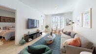 Located at 427 S Hill St in Downtown Los Angeles, this 2-bedroom unit presents a clean, contemporary design characterized by light wood-style flooring, crisp white walls, and recessed lighting throughout. The open-concept living area is bright and inviting, featuring large windows with slatted blinds that allow ample natural light to fill the space. The living room comfortably accommodates a full seating arrangement and provides a dedicated dining nook positioned near the windows.

The kitchen is thoughtfully designed with white shaker-style cabinetry extending to the ceiling, a white quartz countertop, a subway tile backsplash, and stainless steel appliances including a refrigerator, microwave, and range. A peninsula with pendant lighting overhead offers additional seating, making it ideal for casual dining or entertaining.

The two bedrooms each offer distinct character: one features soft sage-green walls and a large window with outdoor views, while the other showcases warm mauve-toned accent walls and a stylish four-poster bed frame. Both rooms are finished with the same light wood flooring found throughout.

Two full bathrooms serve the unit, each featuring tiled tub-shower combinations, white vanities with ample storage, and neutral tile flooring, maintaining the clean, modern aesthetic of the overall space.