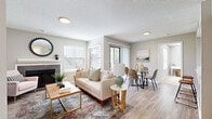 Located at 801 Green Heron Court in Kissimmee, Florida, this single-floor, 2-bedroom, 2-bathroom residence offers a well-organized and efficiently designed layout. The open living and dining area serves as the heart of the home, featuring light wood-style flooring, a textured ceiling, and a tile-surround fireplace flanked by large windows that allow abundant natural light to fill the space. The kitchen is equipped with white shaker-style cabinetry, white countertops, a subway tile backsplash, and black appliances, offering a clean and functional workspace. The primary bedroom provides a comfortable retreat with plush carpeting, a ceiling fan, a walk-in closet, and an en-suite bathroom featuring white vanity cabinetry and light countertops. The second bedroom also features carpet flooring and neutral tones, ideal for guests or a home office. The second bathroom mirrors the updated finishes of the first, with a round mirror, white cabinetry, and wood-style tile flooring. A dedicated in-unit laundry room with a full-size washer and dryer adds everyday convenience. Two closets provide ample storage throughout. The overall ambiance is light, neutral, and move-in ready.