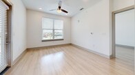 This contemporary 980 square foot apartment offers a harmonious blend of style and functionality. The open-concept living area seamlessly integrates the kitchen and living room, creating a spacious feel. Light wood flooring runs throughout, complementing the crisp white walls and adding warmth to the space.

The kitchen is a standout feature, boasting white cabinetry, granite countertops, and a suite of stainless steel appliances. A central island provides additional workspace and casual seating. Large windows in the living area and bedrooms flood the space with natural light and offer scenic views.

The primary bedroom, measuring 160 square feet, provides ample space and includes a ceiling fan for comfort. Both bathrooms feature modern fixtures, granite countertops, and ample storage. A walk-in closet adds to the apartment's storage solutions.

Recessed lighting throughout and strategically placed windows ensure the space is well-lit. The apartment's layout maximizes efficiency, with no wasted space. Its location at 13730 S Fairview Ave in Baton Rouge, LA, combines urban convenience with a residential feel, making it an ideal home for those seeking a contemporary living experience.