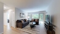 This well-appointed 770-square-foot, one-bedroom, one-bathroom residence is thoughtfully laid out across a single floor, offering a functional and comfortable living experience. Light wood flooring flows throughout, creating a cohesive and airy feel across all rooms.

The living room is spacious and bright, featuring large sliding glass doors that open to a private balcony overlooking a dense, lush tree canopy — providing both natural light and a serene outdoor retreat. The dining area is positioned adjacent to the living space and benefits from a nearby window, creating an inviting spot for meals.

The kitchen is fitted with warm walnut-toned cabinetry, white countertops, and stainless steel appliances including a gas range, built-in microwave, and dishwasher, all accented with matte black hardware. A dedicated laundry area houses a full-size side-by-side top-loading washer and dryer with overhead shelving for additional storage.

The primary bedroom spans 180 square feet and features a ceiling fan with light, natural light from a window with outdoor views, and ample room for furnishings. The bathroom offers a clean, minimal design with a tub/shower combo, white tile surround, and matte black fixtures. A hallway connects the rooms efficiently, completing this well-organized and modern single-floor unit.