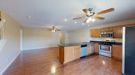 Located at 522 Blackstone Drive in Morgantown, WV, this well-appointed 4-bedroom, 4-bathroom home spans three floors, offering generous living space throughout. The main level centers around an open-concept kitchen and living room, where rich hardwood flooring and ceiling fans set a warm, welcoming tone. The kitchen is equipped with stainless steel appliances, warm maple cabinetry, dark granite countertops, and a central island with a built-in sink — ideal for both everyday living and entertaining. A white-railed staircase connects the floors with classic charm. Hallways with panel-style doors lead throughout the home, maintaining a clean and consistent aesthetic. The bedrooms feature plush carpeting, ceiling fans, and natural light from well-placed windows. The spacious primary bedroom provides a comfortable private retreat. Four full bathrooms are distributed across the floors, including a compact half-bath with hardwood-style flooring and dark vanity cabinetry. A dedicated game room adds versatile living space, while two balconies and a patio extend the home outdoors. The attached garage offers ample storage and convenient access. With nine closets, a laundry room, and multi-floor layout, this home delivers practical functionality throughout.