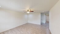 Located at 2200 Beverly St in Bridge City, Texas, this single-story, 3-bedroom, 2-bathroom home offers a practical and well-organized layout. The open kitchen-living area serves as the heart of the home, with the galley-style kitchen featuring white shaker cabinetry with brushed nickel hardware, gray laminate countertops, a double stainless steel sink, and black appliances including a refrigerator, range, microwave, and dishwasher. Light wood-look flooring flows through the main living areas and kitchen, lending the space a clean, contemporary feel. The spacious primary bedroom includes light wood-look flooring, a ceiling fan with light fixture, and a large window that brings in natural light. The two additional bedrooms are carpeted and each equipped with ceiling fans, offering comfortable, versatile spaces. Both bathrooms feature tub-shower combinations with white tile surrounds and brushed nickel or gold fixtures. A dedicated laundry room provides washer and dryer hookups alongside upper white cabinetry for added storage. The home also includes a hallway, a closet, and recessed lighting in select areas, completing a thoughtfully functional living space.