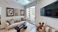 This thoughtfully designed two-bedroom, two-bathroom residence in Phoenix, Arizona presents a clean, contemporary aesthetic throughout its efficiently arranged single-floor layout. Light wood-style flooring flows seamlessly across the living spaces, complementing the bright, neutral palette that defines the home's modern character.

The living room is a welcoming, light-filled space anchored by a ceiling fan and sliding glass doors that open onto a private balcony, offering outdoor views and abundant natural light. The adjacent dining area provides an intimate setting, while the kitchen features rich dark cabinetry, granite-style countertops, a blue tile backsplash, and a full suite of stainless steel appliances including a refrigerator, range, and built-in microwave.

The primary bedroom is a calm, restful retreat with a ceiling fan, wood-style flooring, and direct access to a dedicated closet. The second bedroom is equally well-appointed. Both bathrooms are finished with dark wood vanities and stone-topped counters — one featuring a shower with a glass enclosure, the other with a tub and shower combination. A dedicated in-unit laundry area with shelving adds everyday convenience. Two closets provide ample storage throughout the home.