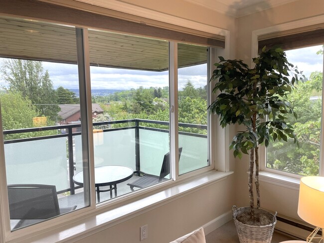 Enjoy morning coffee on the large, covered deck. - 5818 NE 70th St