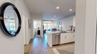This thoughtfully designed 1-bedroom, 1-bathroom unit offers a single-floor open-concept layout that maximizes functionality and flow. The kitchen serves as a central hub, featuring crisp white cabinetry, granite countertop surfaces, a tile backsplash, and a full suite of stainless steel appliances including a refrigerator, range, microwave, and dishwasher. A peninsula island with seating for multiple guests bridges the kitchen to the living area, making it ideal for entertaining.

The living room is bright and inviting, highlighted by a ceiling fan, recessed lighting, and a sliding glass door that opens to a private balcony with outdoor views. Wide-plank wood-style flooring runs throughout the main living areas, adding warmth and continuity.

The bedroom is a comfortable retreat with a ceiling fan, a large window that draws in natural light, and access to a hallway. The bathroom is finished with granite countertops, white shaker-style cabinetry with ample storage, a full tub-shower combination with marble-style tile surround, and wood-style flooring.

A hallway connects the rooms with ease, while neutral wall tones and recessed lighting throughout create a clean, modern aesthetic that feels open and welcoming.
