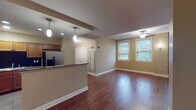 Located at 127 S Roach St in Jackson, Mississippi, this single-floor residence offers a thoughtfully designed open-concept layout that blends functionality with comfort. The living area features rich, dark hardwood flooring and warm neutral-toned walls, creating an inviting atmosphere. A ceiling fan provides both practical comfort and a finishing architectural touch, while multiple windows fitted with blinds allow for ample natural light throughout.

The kitchen is a standout feature, boasting a peninsula with dark granite countertops, warm wood cabinetry, a black subway tile backsplash, and a full suite of stainless steel appliances including a refrigerator with ice maker, electric range, built-in microwave, and dishwasher. Pendant lighting over the peninsula adds a polished, modern touch, and tile flooring ties the space together cleanly.

The bedrooms offer plush carpeting, ceiling fans, and multiple windows that invite natural light and outdoor views. Generous closet space, including double-door closets, adds practical storage. The bathrooms are well-appointed with tile flooring, granite-topped wood vanities, and tiled tub-shower combinations. Clean white finishes and natural light from windows give the bathrooms a bright, functional character throughout.