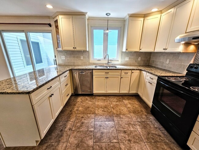 Kitchen with dishwasher, garbage disposal, electric stove, granite counters, tile backsplash. - 30 Fairfield Ave
