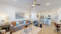 This thoughtfully designed 1-bedroom, 1-bathroom single-story residence offers an efficient and functional layout that maximizes every square foot. The open-concept living and kitchen area serves as the heart of the home, featuring light wood-look flooring, recessed lighting, and a ceiling fan that enhances the bright, airy atmosphere. Large windows allow natural light to fill the living space, which is further complemented by clean white walls and a neutral color palette.

The kitchen is a standout feature, showcasing white shaker-style cabinetry, light quartz countertops, a peninsula with bar seating, pendant lighting, and a full suite of stainless steel appliances including a refrigerator, gas range, and microwave. The seamless flow between the kitchen and living area makes the space ideal for both everyday living and entertaining.

The bedroom is a comfortable retreat, offering a window with natural light, wood-look flooring, and ample room for furnishings. The bathroom features a clean, minimal design with a shower and modern finishes throughout. A dedicated laundry area with a full-size washer and dryer adds exceptional convenience, while a closet provides additional storage. The overall ambiance is modern, clean, and inviting.