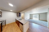 Located in Snoqualmie, WA, this well-designed 4-bedroom, 2-bathroom single-floor home offers a thoughtful layout suited for comfortable everyday living. The open-concept kitchen and living area serves as the heart of the home, featuring warm hardwood-style flooring, recessed lighting, and a peninsula with a countertop sink and dishwasher. Dark espresso cabinetry contrasts beautifully with light countertops, while stainless steel appliances — including a refrigerator, range, and microwave — complete the functional kitchen. The living area transitions seamlessly from hardwood flooring to plush carpeting and opens to a private balcony with views of mature Pacific Northwest evergreens. Each of the four bedrooms is carpeted and offers a calm, neutral palette, with select rooms featuring windows that frame serene wooded views. The primary bathroom is equipped with a dual-sink vanity topped with a wide mirror, dark wood cabinetry, and light tile flooring, while the second bathroom includes a full soaking tub with shower. Abundant storage is a standout feature, with seven closets throughout — including walk-in closets with wire shelving systems. A dedicated laundry area and hallway complete the practical layout of this serene Snoqualmie residence.
