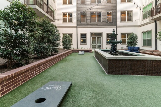 Main courtyard features a boutique, infinity-edge swimming pool and outdoor fire place - Stella Apartments