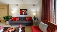 Located at 2 Lockhart Circle in Forest Hill, Maryland, this single-floor residence offers a well-organized layout designed for comfortable everyday living. The living room serves as the central gathering space, featuring plush carpeting, large windows with views of surrounding greenery, and ample room for seating. Natural light flows freely through the space, creating a warm and inviting ambiance throughout.

The dining area is positioned adjacent to the living room and accommodates a round glass-top table with seating for four, complemented by a ceiling fan and a closet for added storage. The kitchen is equipped with white cabinetry accented by wood trim, a full suite of white appliances including a range and refrigerator, generous counter space, and tile flooring that provides a clean, practical finish.

Both bedrooms offer carpeted floors, large windows with outdoor views, and spacious closets. The primary bedroom includes an en-suite vanity area with a wide countertop and a large mirror. A full bathroom with a tub-shower combination and tile flooring serves the residence. Throughout the home, neutral wall tones provide a versatile backdrop, while consistent design choices lend a cohesive and functional character to every room.