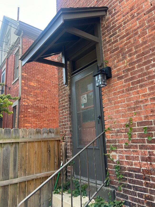 Back door entrance off of patio and fenced yard. Parking for one car on gravel lot. - 1152 Jaeger St